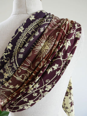 Patterned fabric draped over a mannequin on a white background