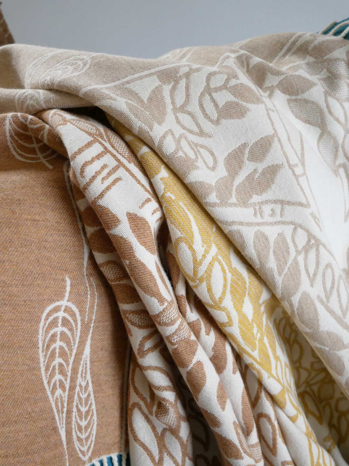 Collection of patterned fabrics in beige, brown, and yellow.