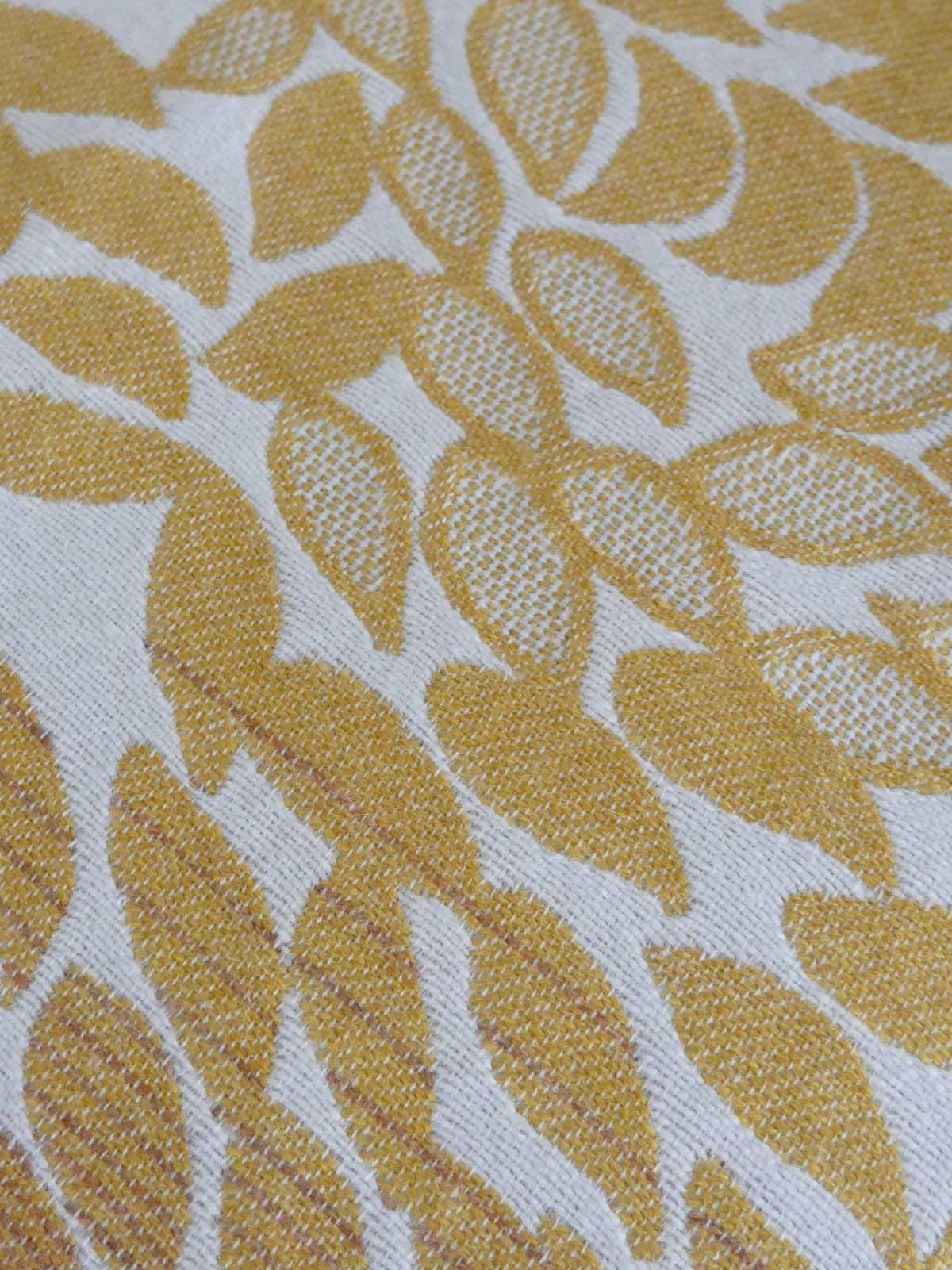 Textile with yellow leaf pattern on a white background