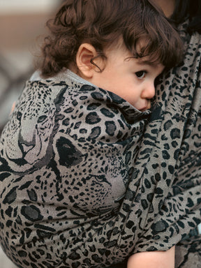 Child wrapped in a leopard print Prowl Savannah Baby Wrap