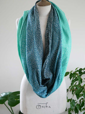 Teal patterned Sekaibloom Wave Infinity Loop on a mannequin with a white background
