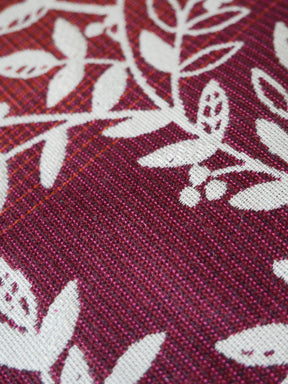Close-up of a burgundy fabric with white floral patterns