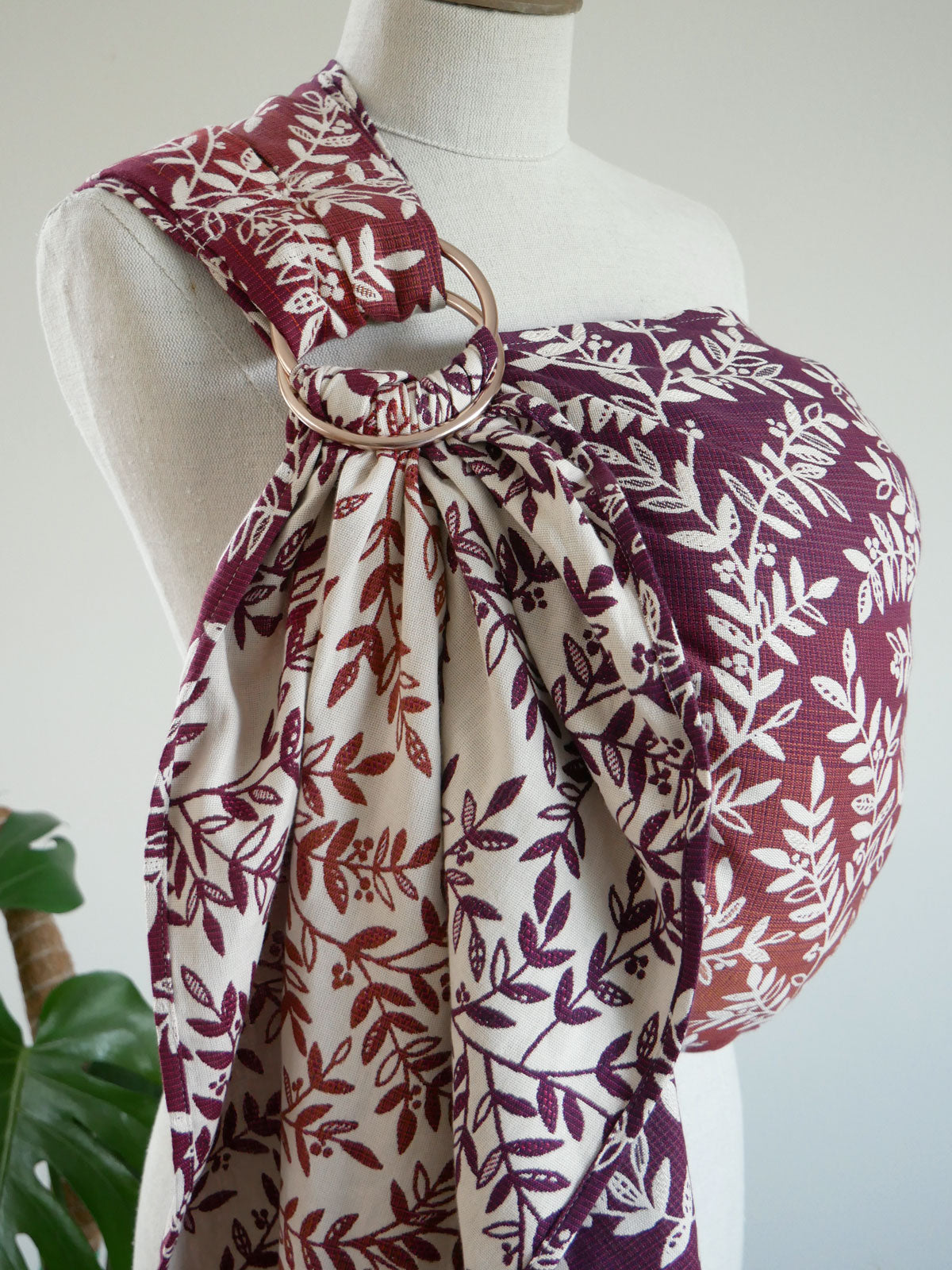 Floral-patterned ring sling on a mannequin against a white background