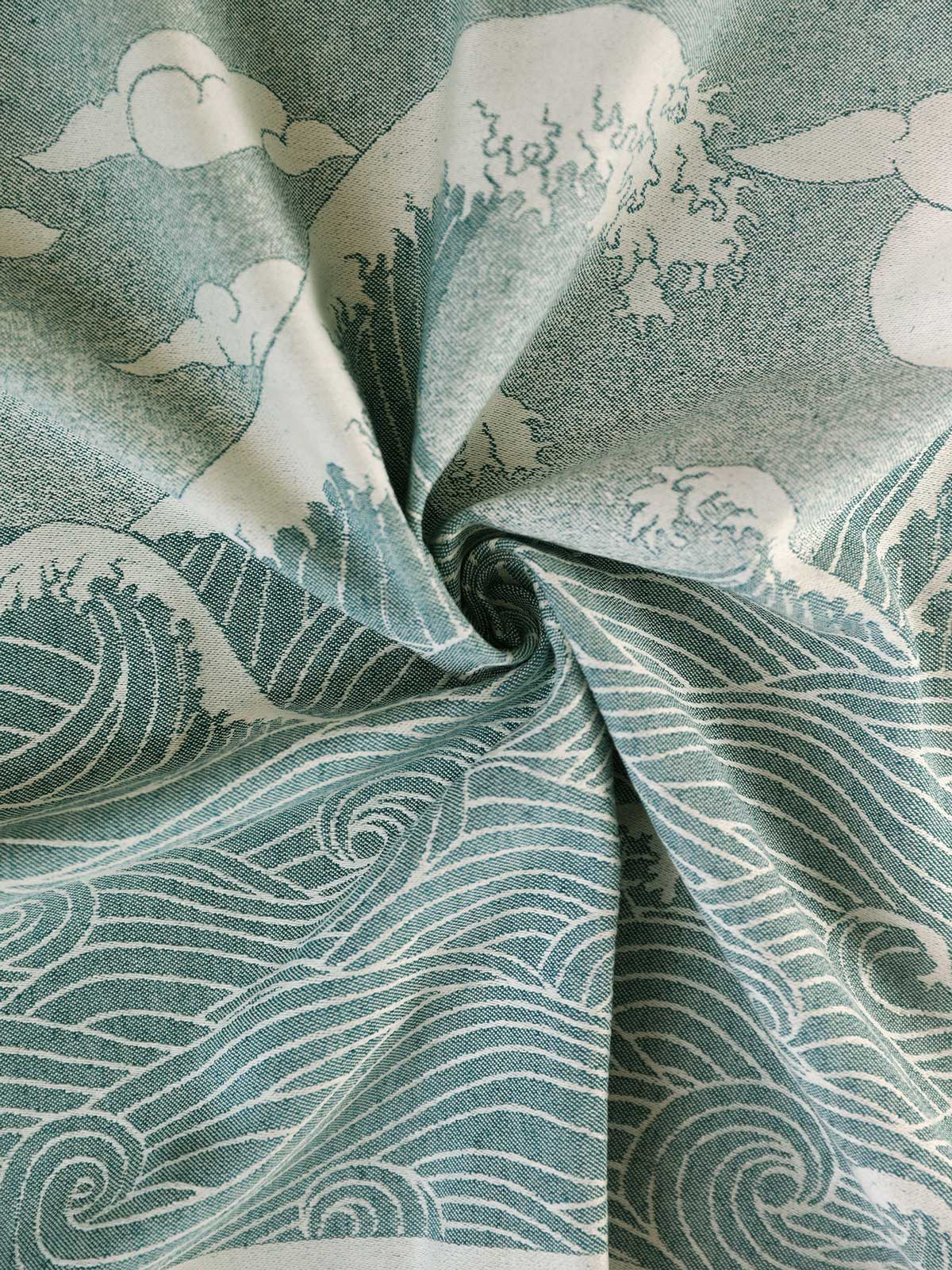 A fabric with a vintage wave pattern in blue-teal and natural ecru tones.